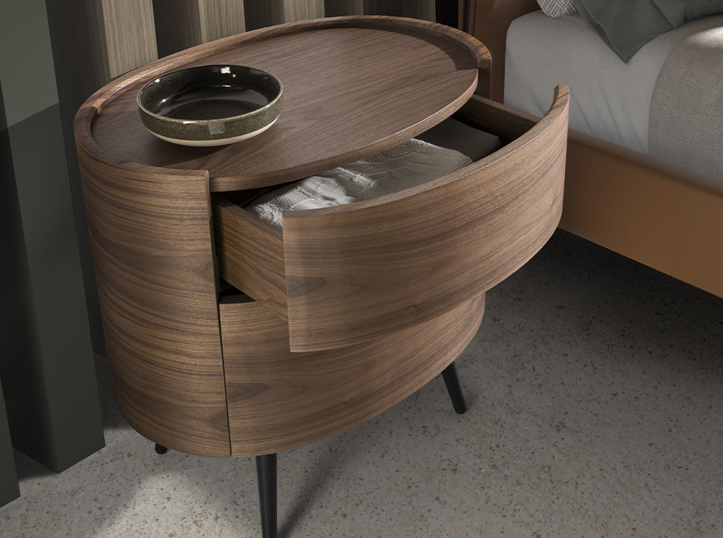 Mesa de noche ovalada de nogal con patas de acero inoxidable Angel Cerdá.