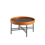 Mesa de café redonda de nogal natural con tapicería de piel de vaca cognac Angel Cerdá