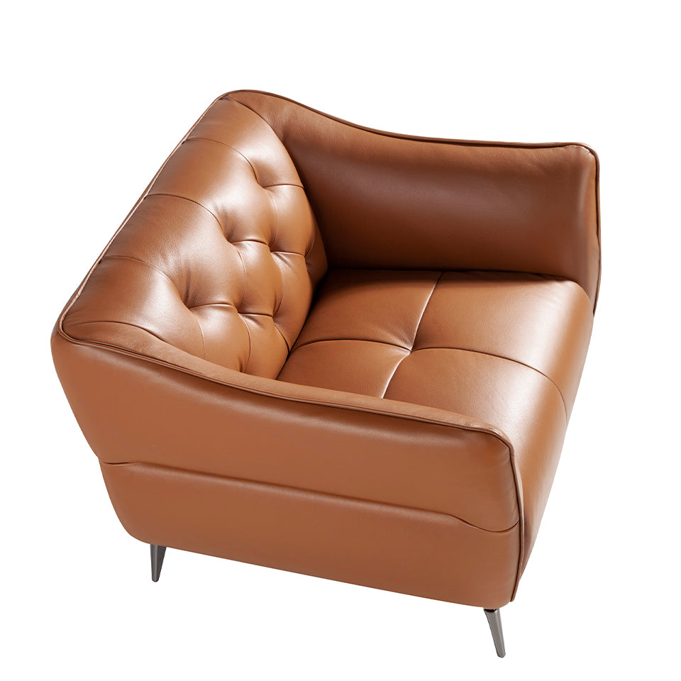 Sillón tapizado en piel marrón con modelo capitoné de Angel Cerdá